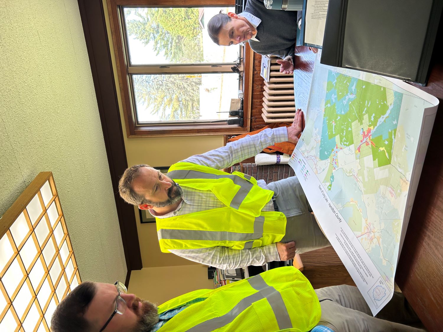 Three people with a map